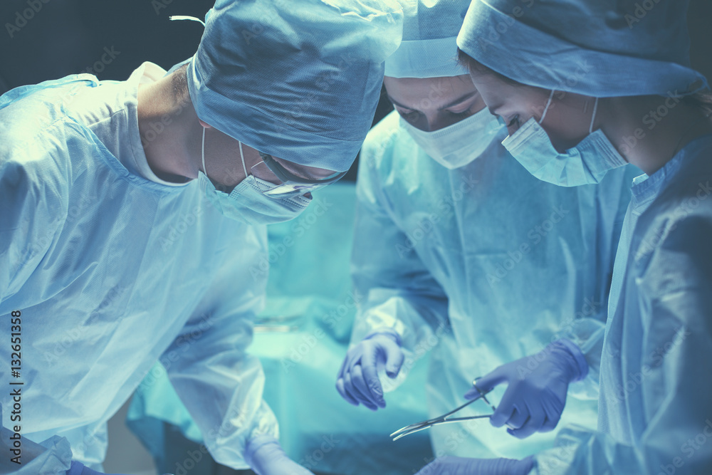 Team surgeon at work in operating room. Team surgeon at work in operating room.