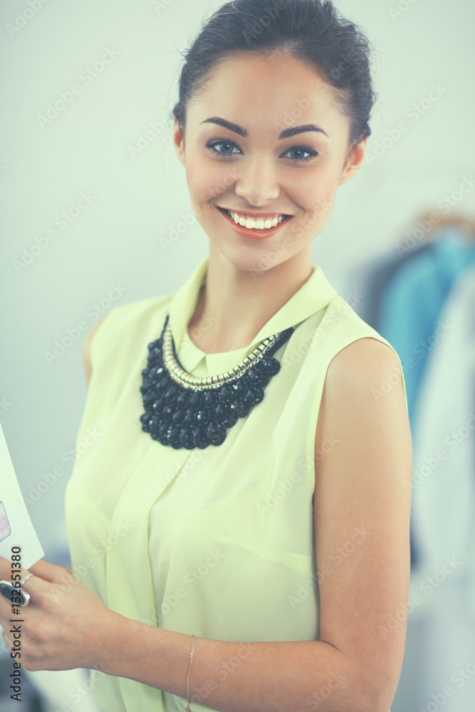 Modern young fashion designer working at studio. Modern young fashion designer working at studio.