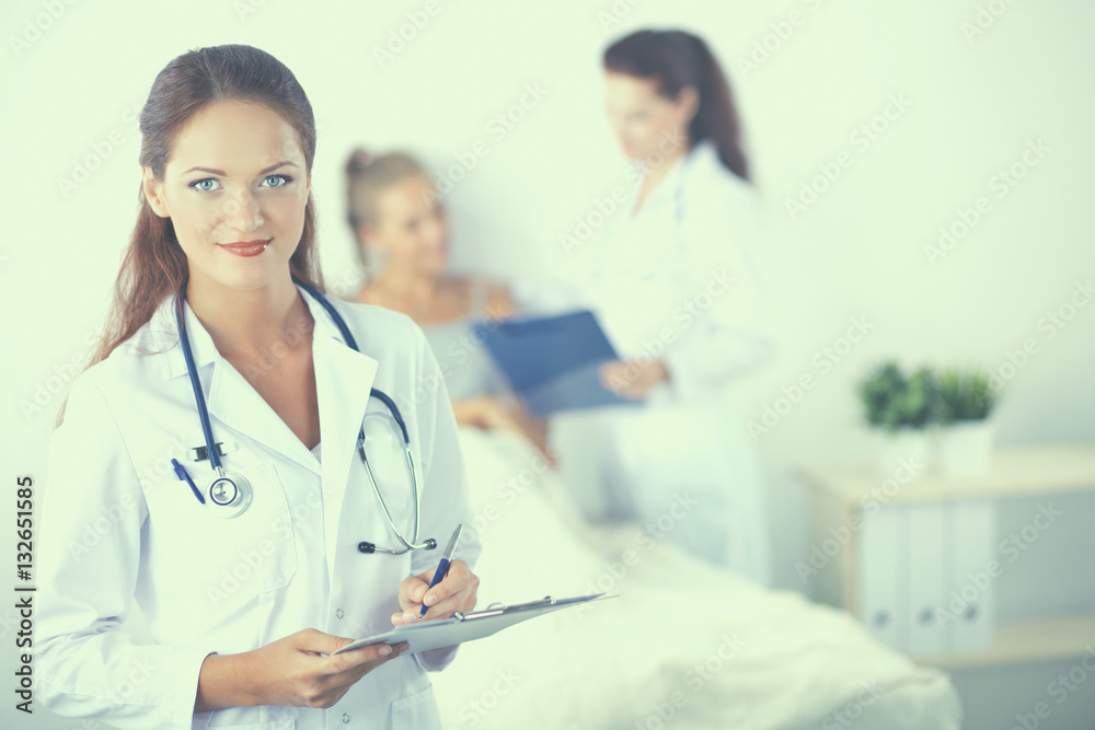 Woman doctor with folder standing at hospital Woman doctor with folder standing at hospital