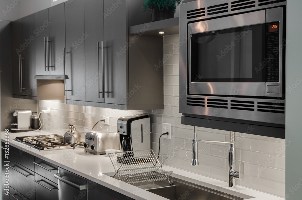 Interior view of kitchen with microwave oven Interior view of kitchen with microwave oven