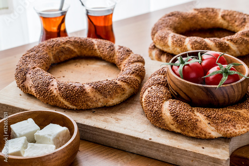 Photography Turkish Bagel Simit with tea, cheese and cherry tomatoes.