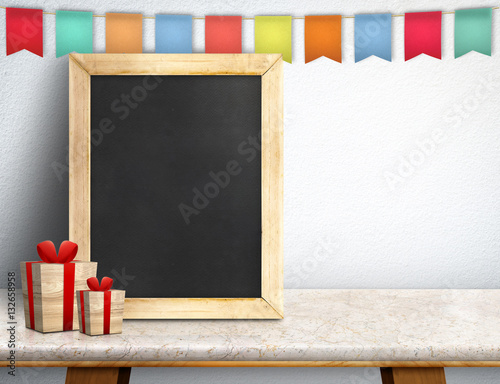 Blank blackboard with gift box and colorful flag banner on marbl photo