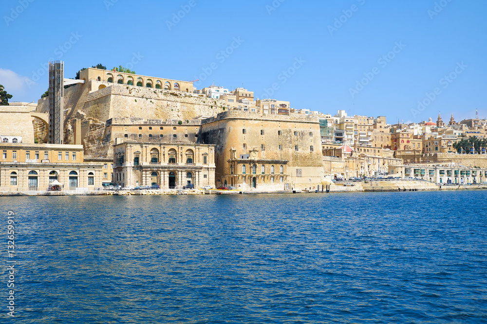 View of Valletta capital city fortifications from the water of G