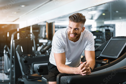Happy smiling man in gym