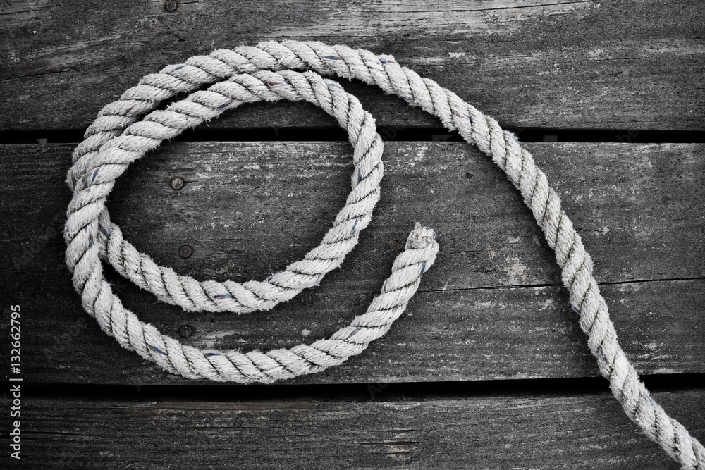 Obraz premium Curled rope on harbor deck