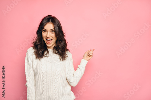 funny surprised girl showing empty copy space with her finger