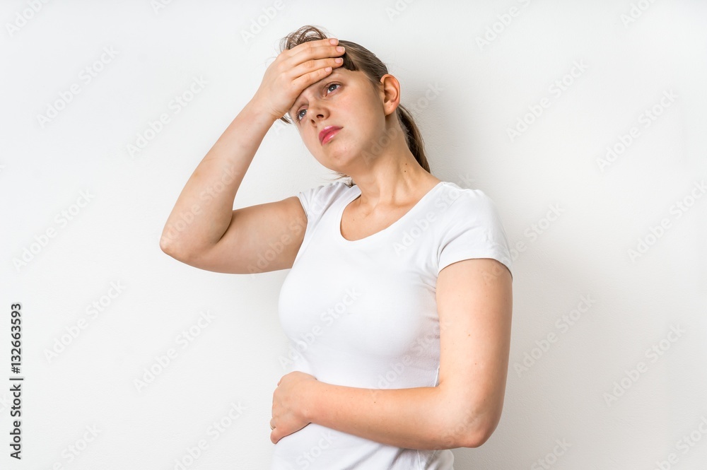 Woman with headache is holding her aching forehead Woman with headache is holding her aching forehead