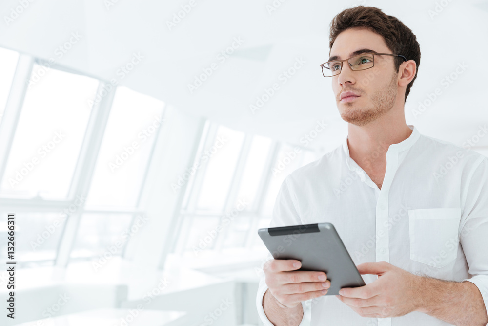 Attractive young man holding tablet computer Attractive young man holding tablet computer