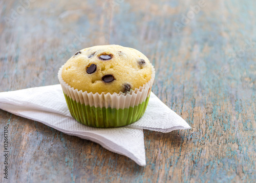 Chocolate Chip Muffin on a Wooden Base. photo