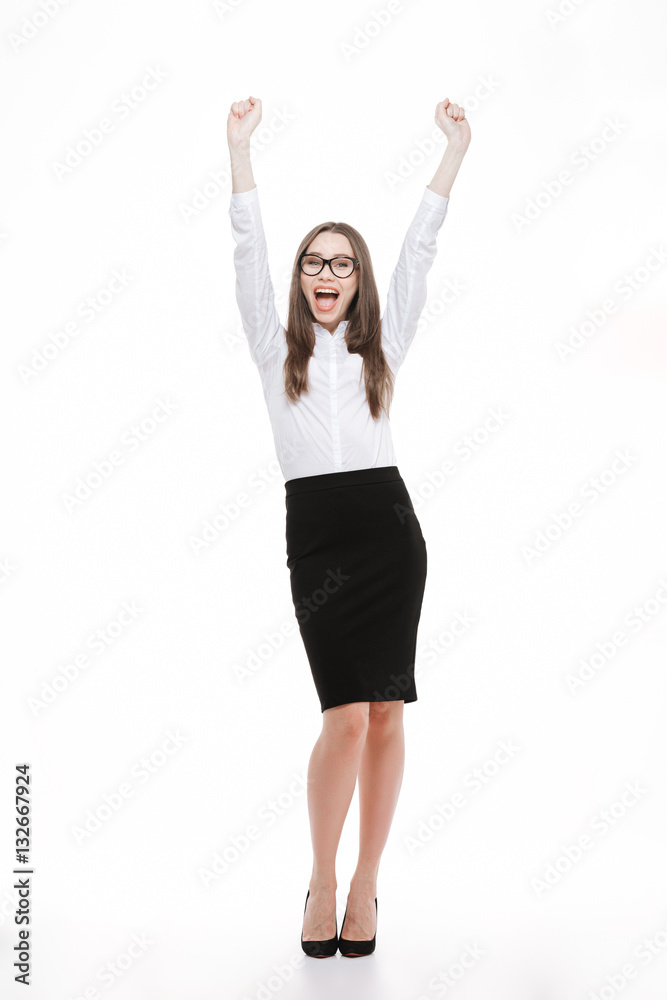 Full length of happy excited young businesswoman celebrating success Full length of happy excited young businesswoman celebrating success