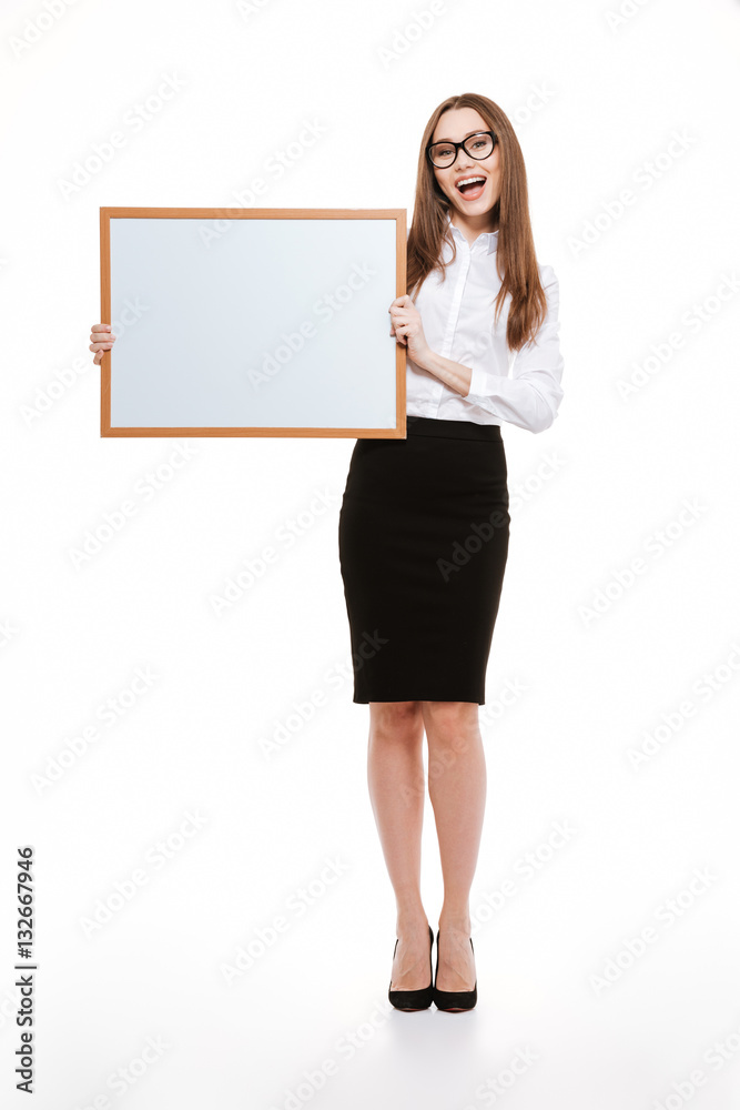 Full length portrait of a beautiful woman holding blank board Full length portrait of a beautiful woman holding blank board