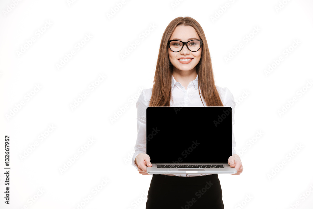Cheerful pretty young business woman holding blank screen laptop Cheerful pretty young business woman holding blank screen laptop