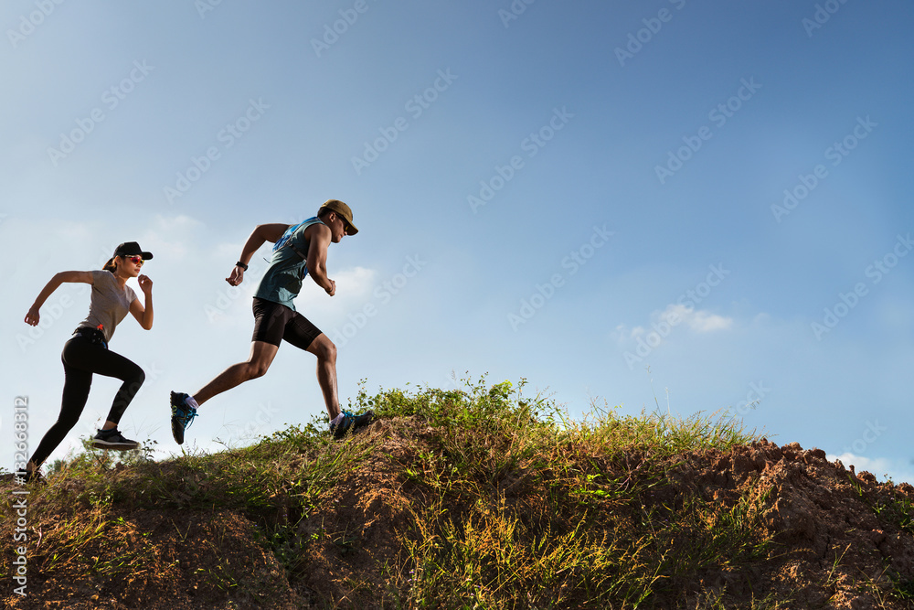 Trail Runner of men and women running on the mountain Trail Runner of men and women running on the mountain