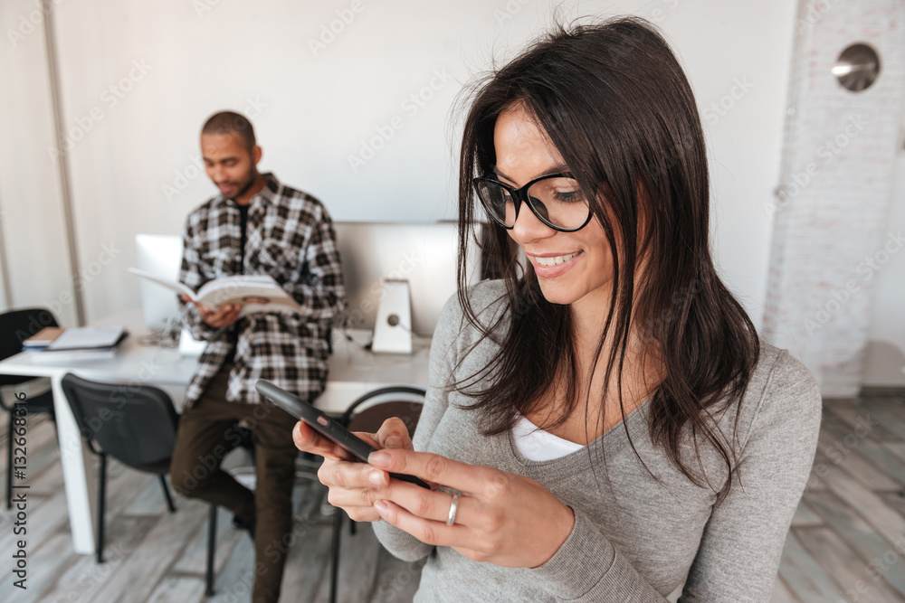 Business partners in office. Man holding magazine and woman chatting. Business partners in office. Man holding magazine and woman chatting.