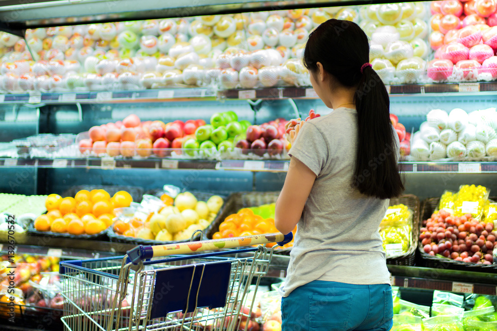 Asian women were shopping for fruit in supermarket