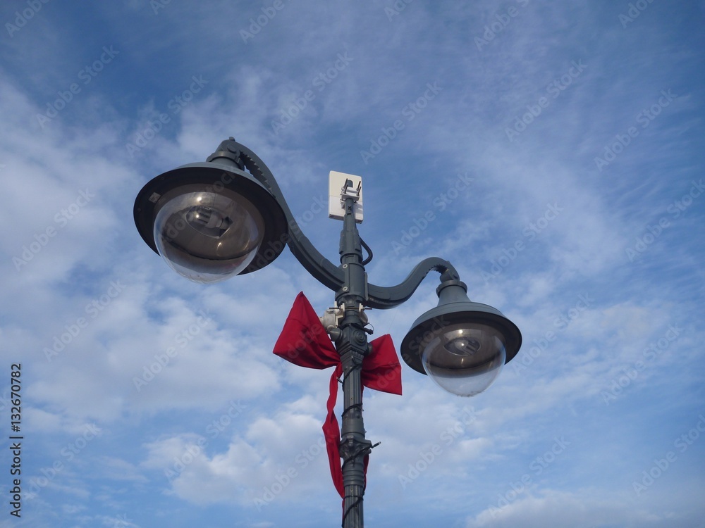 double street lamp decorated with a red ribbon double street lamp decorated with a red ribbon