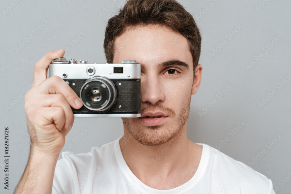 Close up portrait of Man making photo on retro camera Close up portrait of Man making photo on retro camera