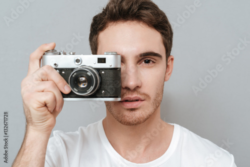 Close up portrait of Man making photo on retro camera