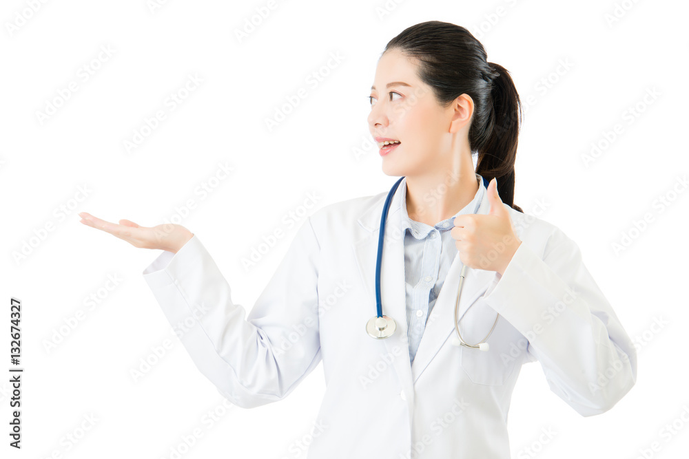 Smiling asian woman doctor display something and thumb up Smiling asian woman doctor display something and thumb up