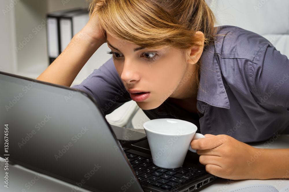 Surprised business woman watching in laptop Surprised business woman watching in laptop