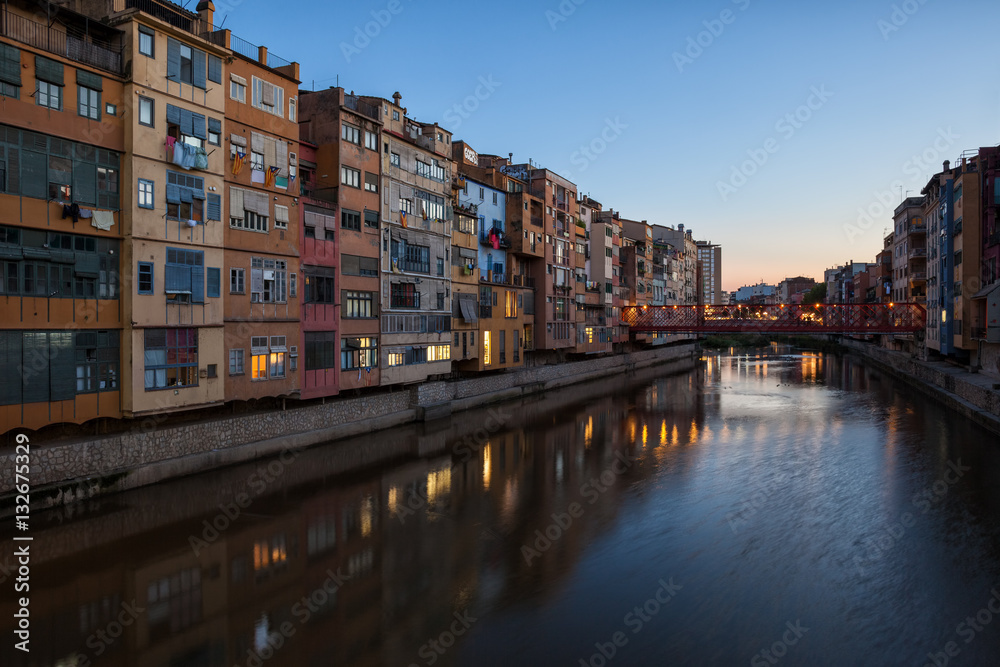 City of Girona at twilight, houses along River Onyar in Old Town