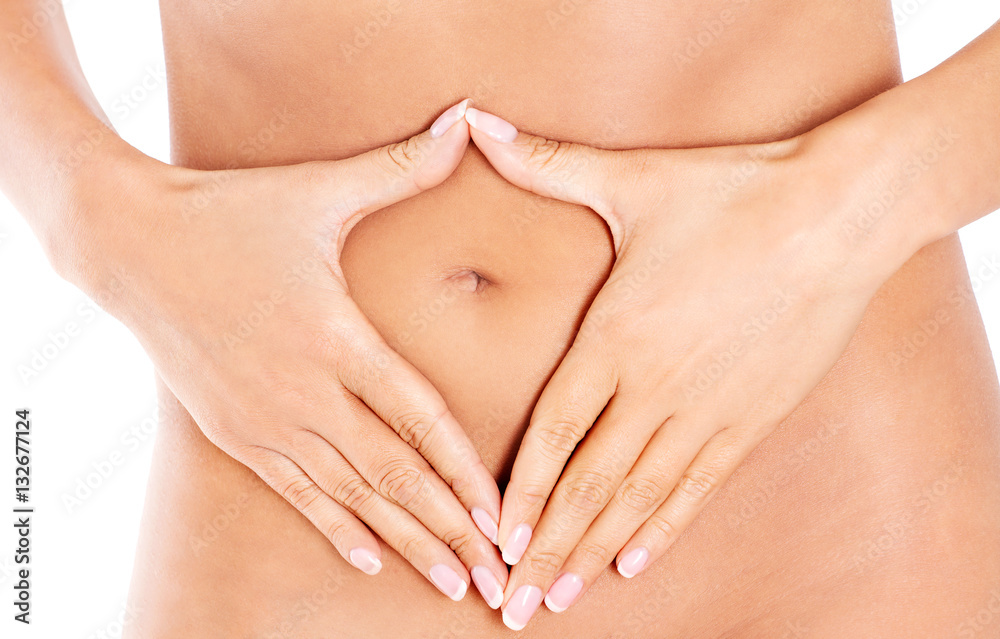 Hands on slim female belly