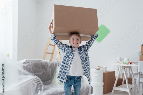 Boy carrying a big box