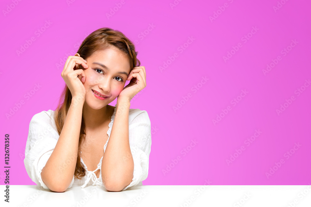 portrait of beautiful girl resting the elbow on white table, half latina and half asian