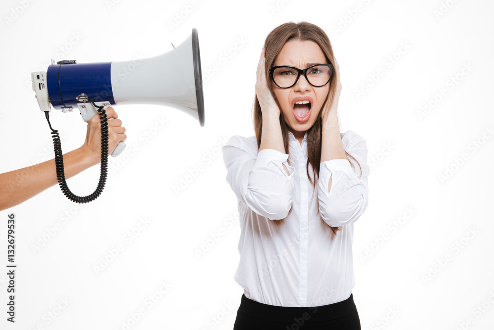 Boss with megaphone yelling at female colleague Boss with megaphone yelling at female colleague