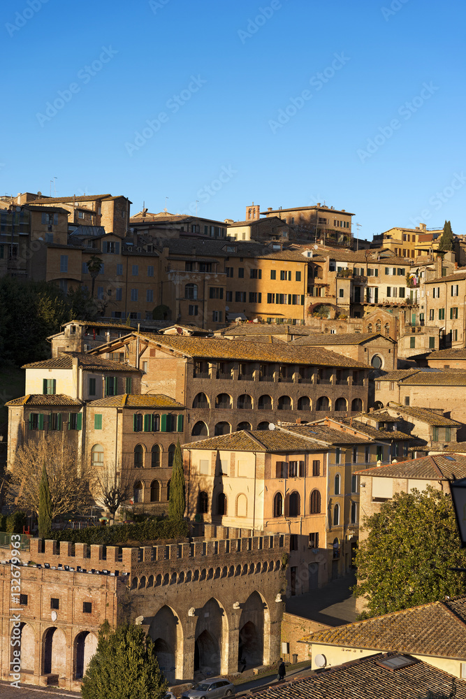 Siena with old houses in the evening. Tuscany, Italy, Europe
