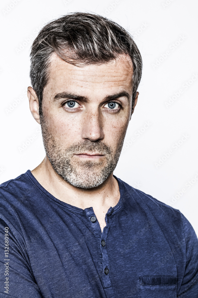 Fototapeta premium portrait, young handsome bearded man with blue eyes and freckles