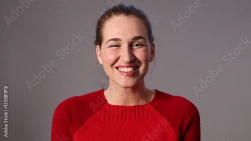 giggling beautiful girl expressing joy, shyness and fun with humor