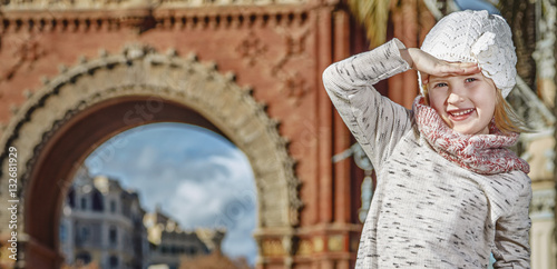 girl near Arc de Triomf in Barcelona looking into distance photo