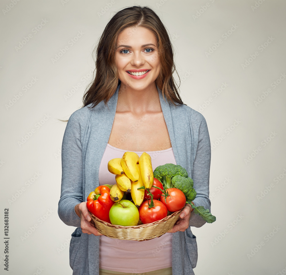 Smiling young woman holding fruit set. Smiling young woman holding fruit set.