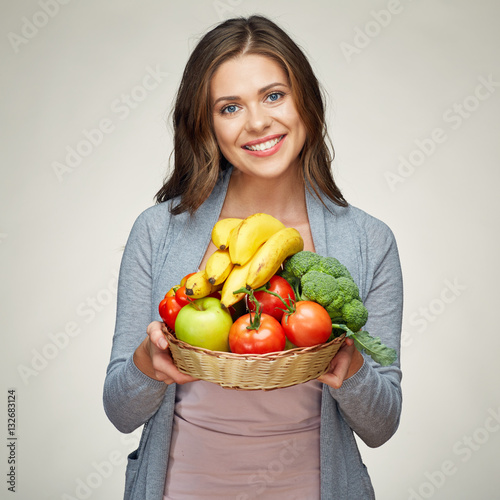 smiling woman hold basket with healthy green food.