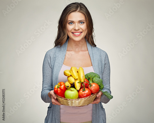 smiling woman hold basket with healthy green food.