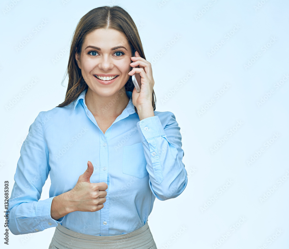Smiling business woman using mobile phone show thumb up. Smiling business woman using mobile phone show thumb up.