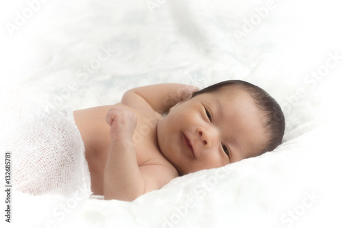 Little asia newborn baby boy 15 days lying on a bed