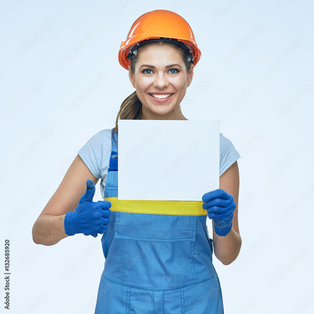 Smiling woman builder worker wearing protect helmet holds white