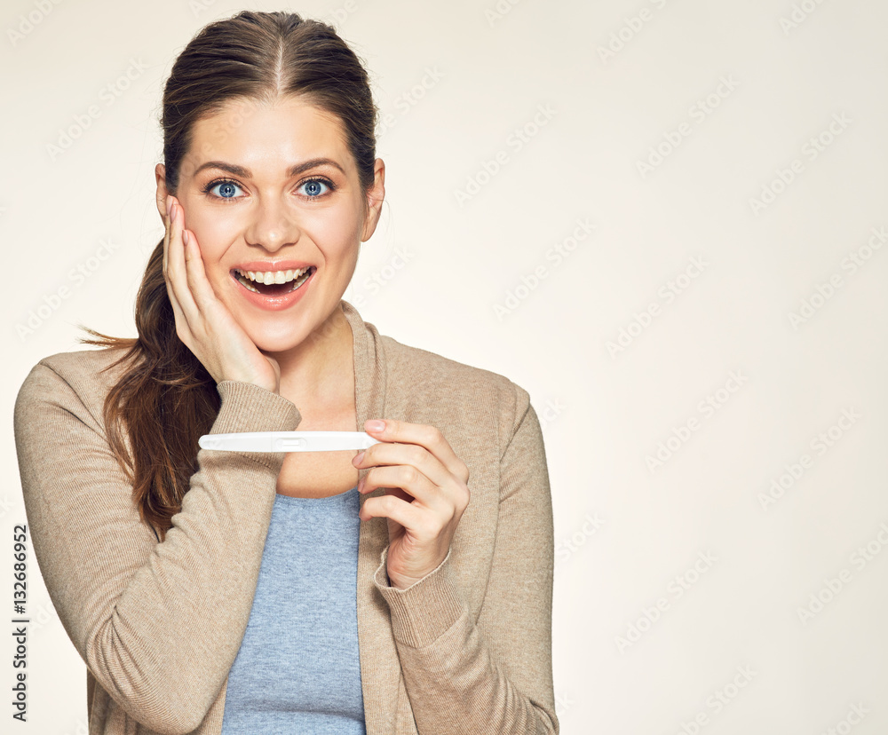 Happy smiling woman holding pregnancy test. Happy smiling woman holding pregnancy test.