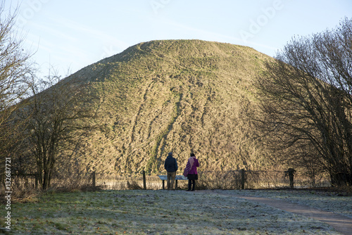  Visitors at the prehistoric Silbury Hill near Avebury in Wiltshire England UK