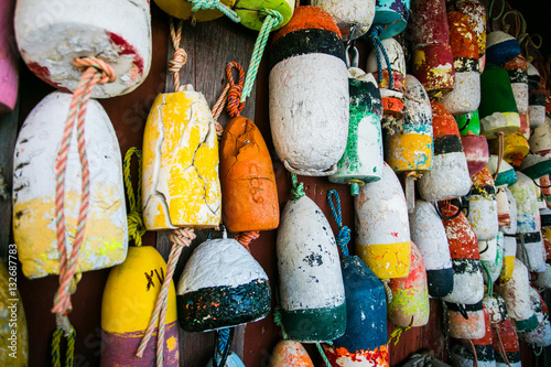 colored fishing floats on wooden wall photo