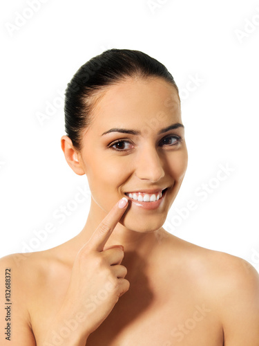 Dental health concept - beautiful woman pointing to her teeth