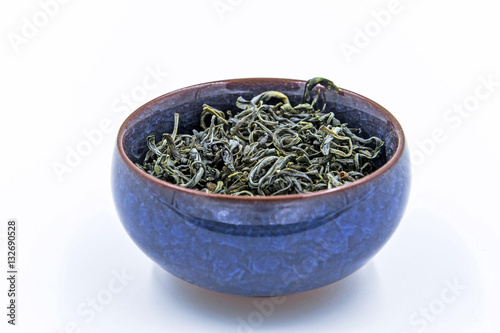 Chinese Green tea. (Huang Shan Mao Feng) in a blue ceramic bowl