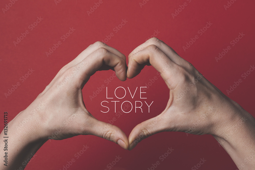 Female hands creating the shape of a love heart around a romantic message. Female hands creating the shape of a love heart around a romantic message.