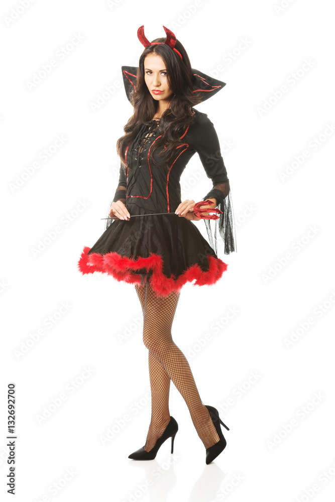 Sexy woman wearing devil clothes, holding trident, looking at the camera Sexy woman wearing devil clothes, holding trident, looking at the camera