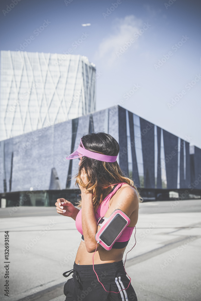 Girl to music on her armband with and headphones Barcelona Stock Photo | Stock