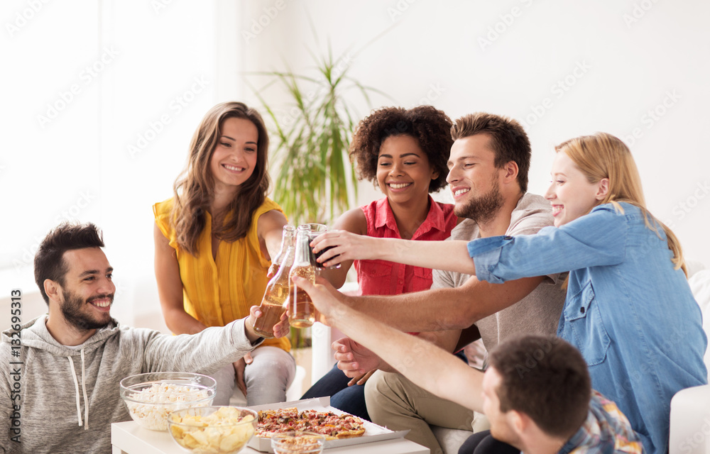 friends having party and clinking drinks at home