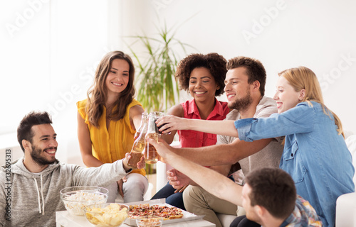 friends having party and clinking drinks at home
