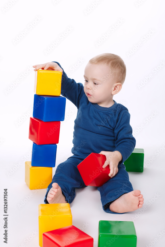 boy plays with cubes on white boy plays with cubes on white